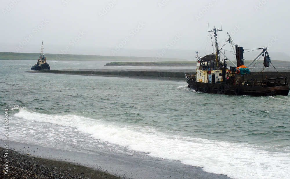 Two fishing vessels in shallow water. Stormy weather. Saltwater fishing industry Two fishing vessels in shallow water. Stormy weather. Saltwater fishing industry