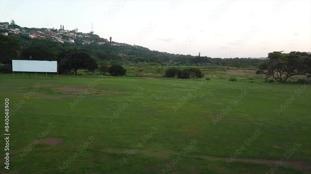 Drone flying low over cricket training nets and an abandoned old building change rooms with a white score board over a rugby field Harlequins on the Bluff in Durban Drone flying low over cricket training nets and an abandoned old building change rooms with a white score board over a rugby field Harlequins on the Bluff in Durban