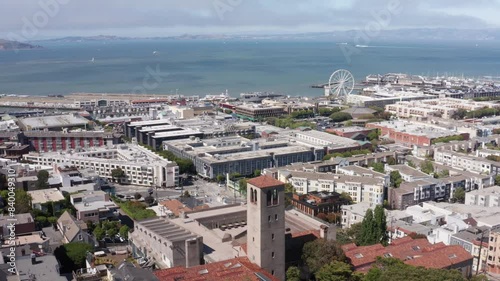 Aerial wide descending shot of Fisherman's Wharf and Alcatraz Island from Lombard Street on Russian Hill in San Francisco, California. 4K