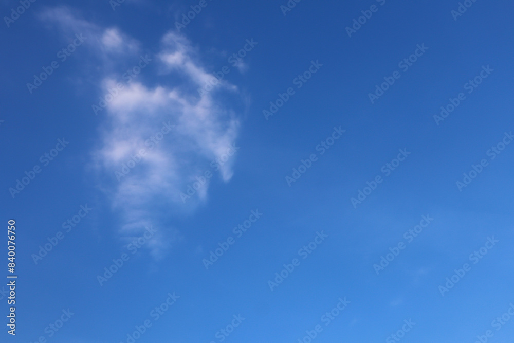 Fluffy white clouds float in the blue sky Fluffy white clouds float in the blue sky