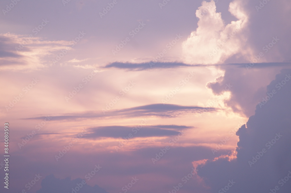Small gray scattered clouds on a pink shiny background on a rainy day. Small gray scattered clouds on a pink shiny background on a rainy day.