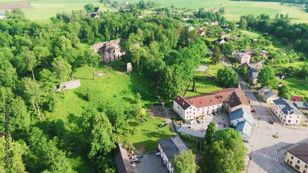 Rauna City, Latvia, Aerial View. Panoramic View From Above to Small Town Rauna in Latvia. Medieval Castle Ruins and Rauna Evangelic Lutheran Church 4K Aerial Shot Rauna City, Latvia, Aerial View. Panoramic View From Above to Small Town Rauna in Latvia. Medieval Castle Ruins and Rauna Evangelic Lutheran Church 4K Aerial Shot