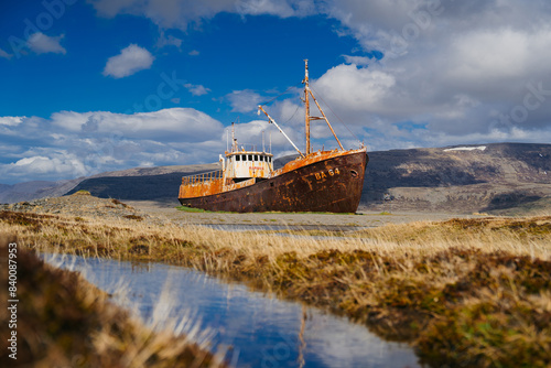 Old shipping boat, Gardar BA 64, shipwrecked aground in the Westfjords of Iceland photo