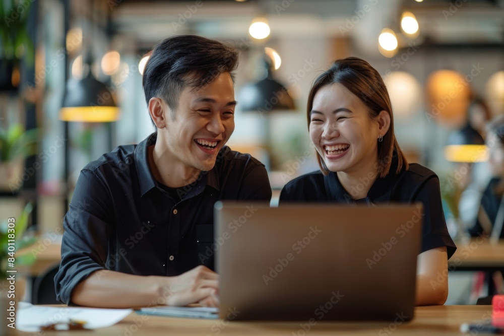 Group laughing at laptop Group laughing at laptop