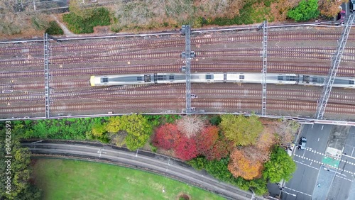 Landscape bird's-eye view of train travelling along railroad tracks commute carriages into Central Station platform Sydney Haymarket Australia transport photo