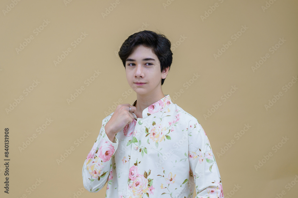 Fashion portrait of the young handsome guy posing casually wearing a Modern Traditional Lanna Dress Shirt decorative motifs. Man who upholds local values. Fashion portrait of the young handsome guy posing casually wearing a Modern Traditional Lanna Dress Shirt decorative motifs. Man who upholds local values.