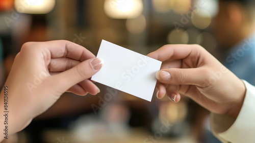 Close-up of a business card exchange between two professionals