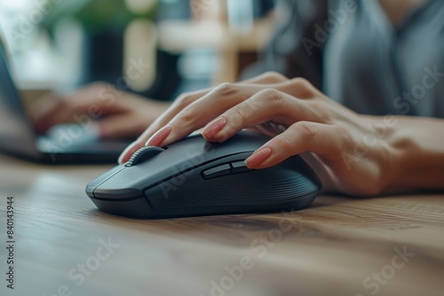 Person operating mouse on desk photo
