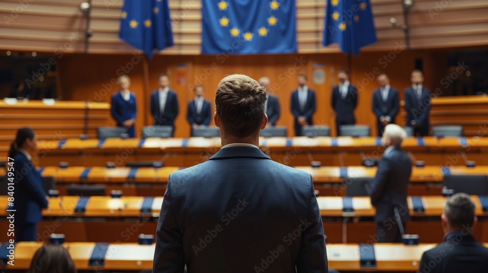 Rear view of a group of people in front of EU flags. Rear view of a group of people in front of EU flags.
