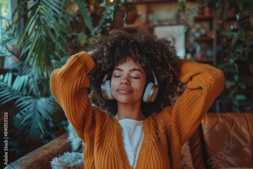 Woman lounging on sofa with headphones