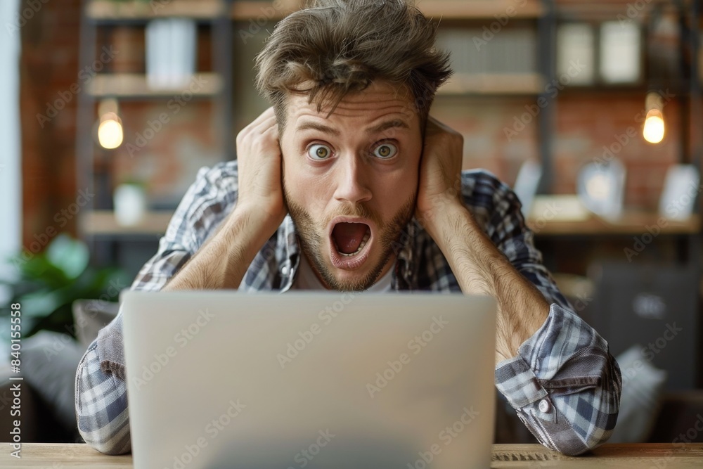 Shocked man viewing laptop Shocked man viewing laptop