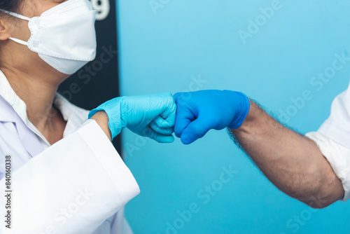 Two caucasian scientist men woman fist bump team partner shake hands together. Teamwork two scientist science chemistry research in laboratory. Close up hands pharmaceutical science team partnership