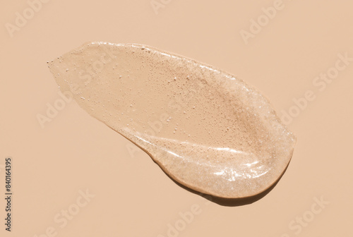 cosmetic smears scrub peeling cream texture on a beige background photo