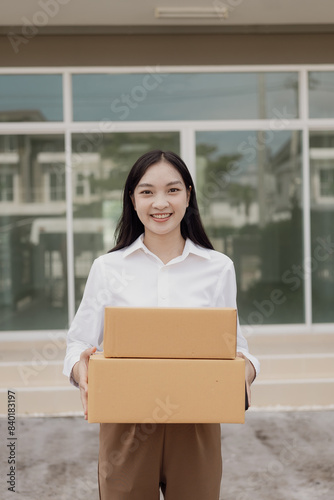 small business owner Asian woman working at home with boxes and laptop Retail market, business and sales, online marketing, SME ecommerce concepts, vertical image © MrAshi
