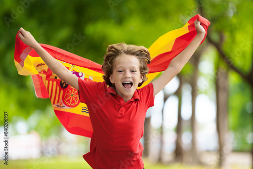 Child running with Spain flag. Little Spanish fan.