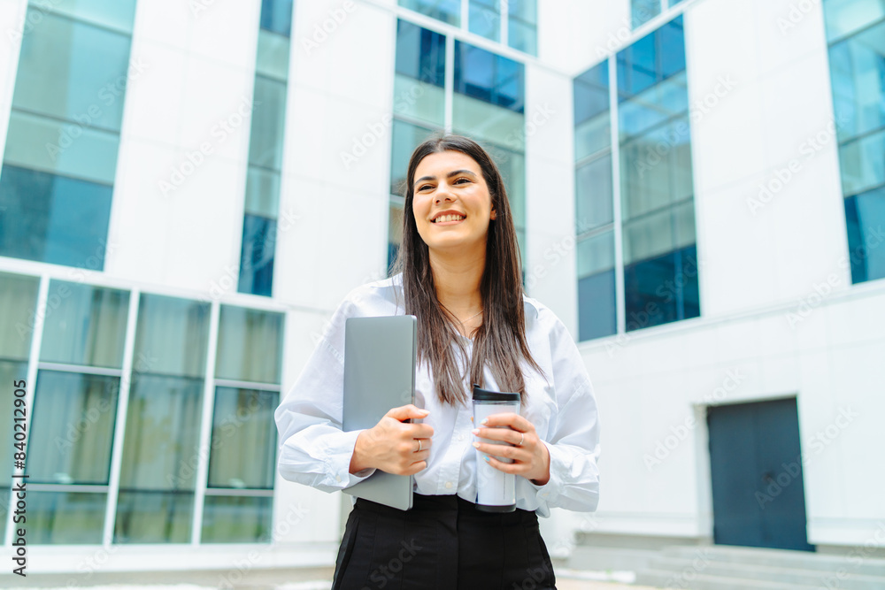 One young successful business woman going to work at business office modern building while holding coffee and laptop
One young successful business woman going to work at business office modern building while holding coffee and laptop