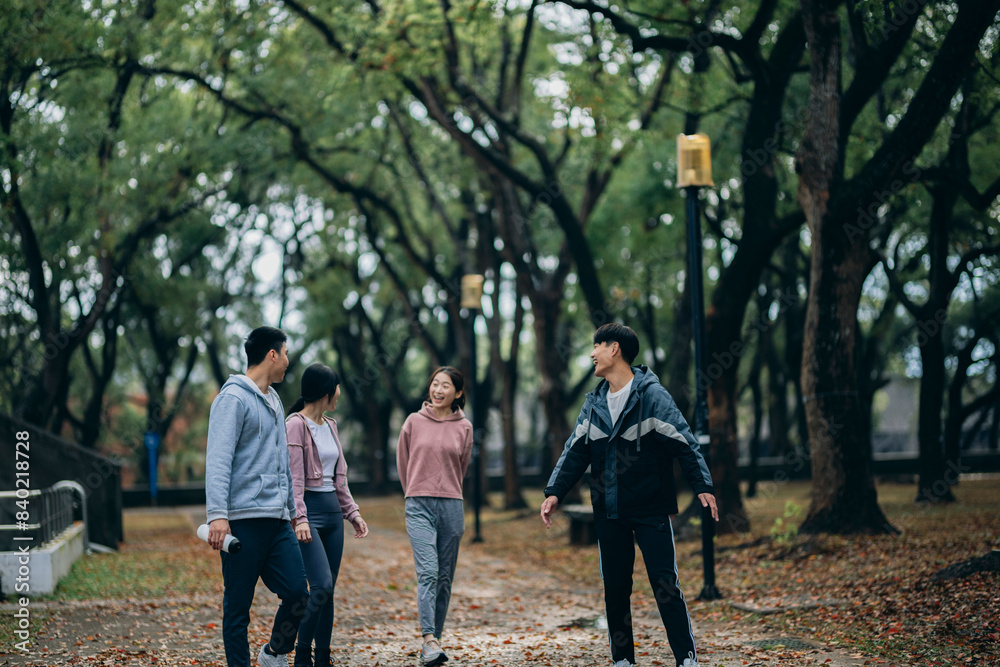 young Asians walk outdoors, sharing their recent exercise experiences as they stroll. They also use reusable water bottles, embodying the concept of sustainable living. young Asians walk outdoors, sharing their recent exercise experiences as they stroll. They also use reusable water bottles, embodying the concept of sustainable living.