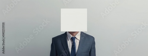 a businessman wearing A white square covering his face stands in front of the body, dressed in a suit and tie against a clean background.
