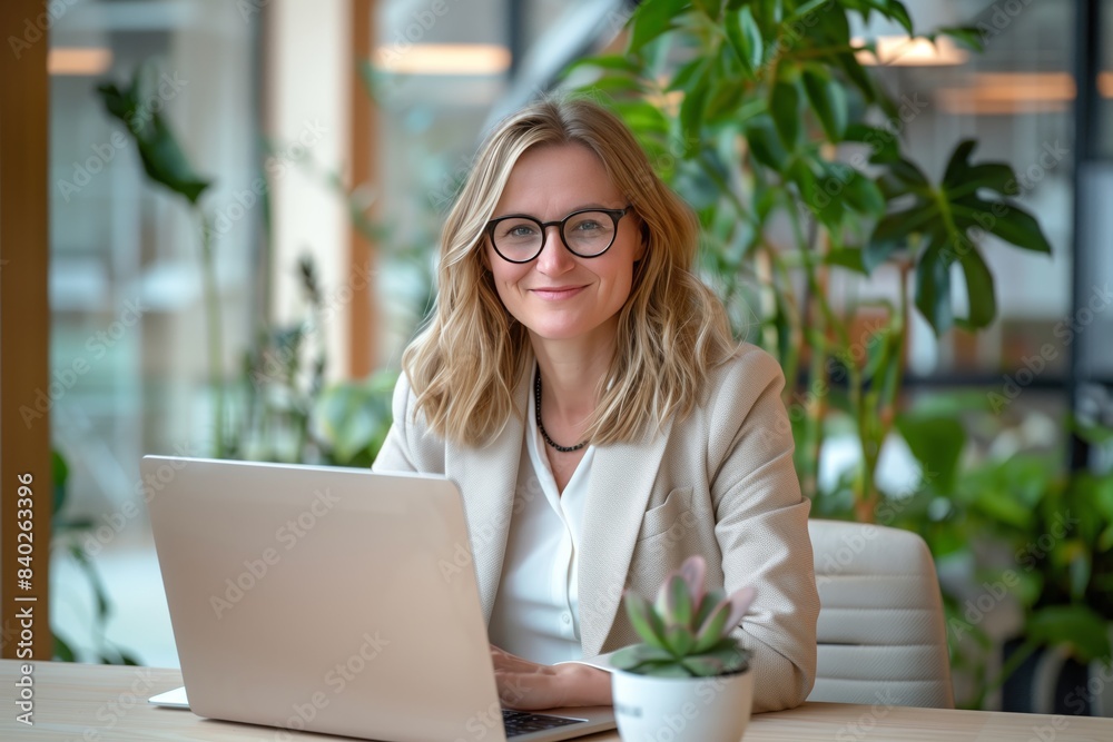 Professional Woman in Her Mid-30s Wearing Glasses in a Modern Office with Greenery. Business Portrait Professional Woman in Her Mid-30s Wearing Glasses in a Modern Office with Greenery. Business Portrait