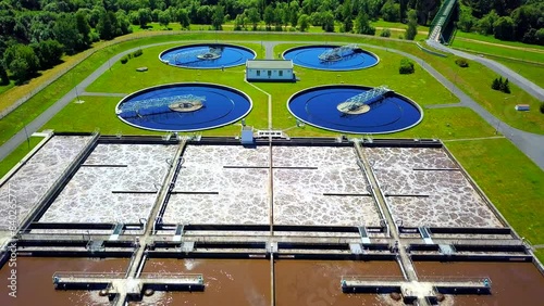 Aerial view of sewage treatment plant. Industrial water treatment for big city from drone view. Flight over waste water management.