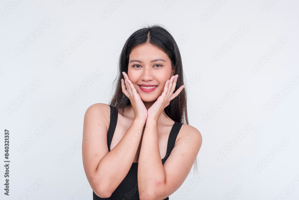 Fresh looking and vivacious asian teen in a black bodysuit expressing excitement. Hands on cheeks. Isolated on a white background. Fresh looking and vivacious asian teen in a black bodysuit expressing excitement. Hands on cheeks. Isolated on a white background.