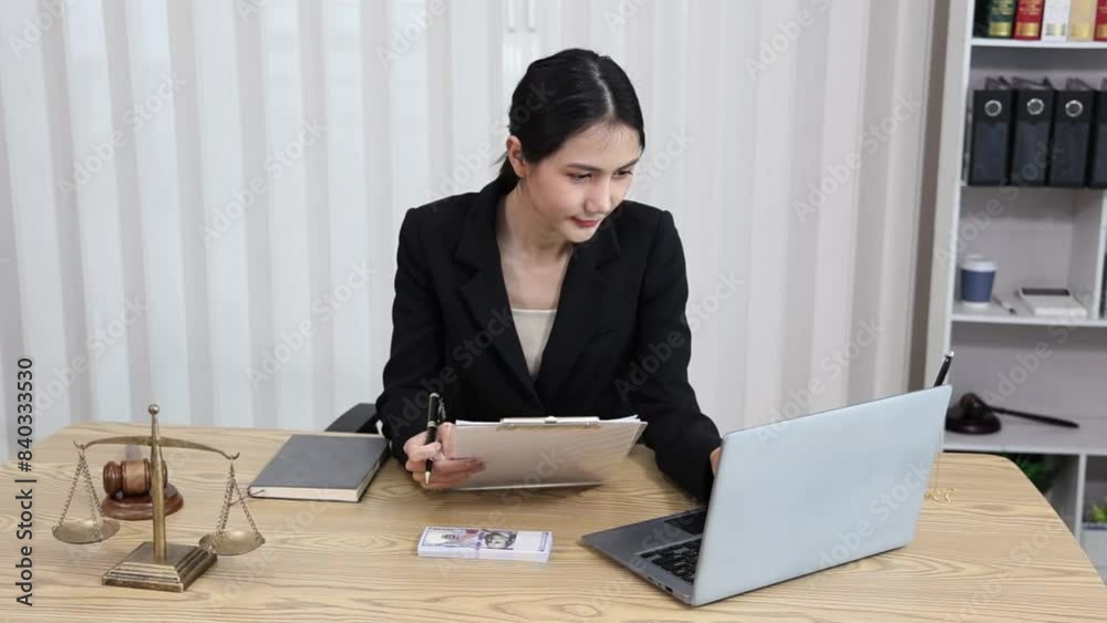 justice and law concept. asian woman lawyer working and judge in a courtroom the gavel, working with tablet and laptop and digital tablet computer on table justice and law concept. asian woman lawyer working and judge in a courtroom the gavel, working with tablet and laptop and digital tablet computer on table