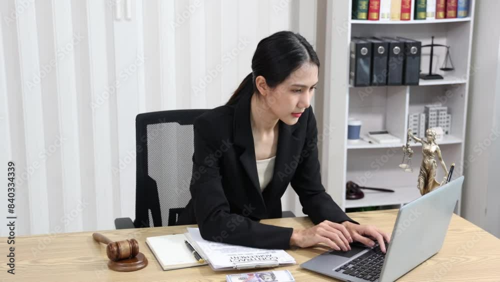 justice and law concept. asian woman lawyer working and judge in a courtroom the gavel, working with tablet and laptop and digital tablet computer on table justice and law concept. asian woman lawyer working and judge in a courtroom the gavel, working with tablet and laptop and digital tablet computer on table