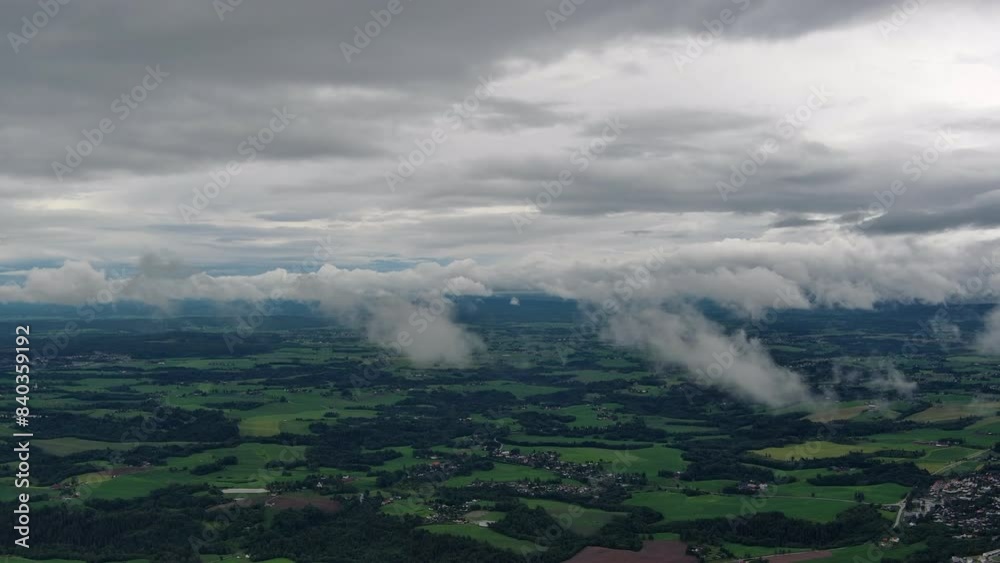 Time lapse from aerial drone of drfting cloud layer - with rural landscape below - Norway