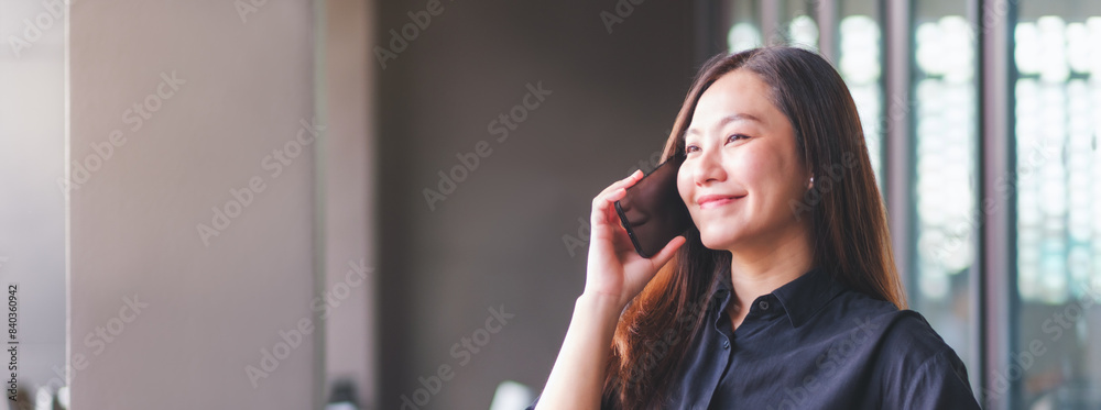 Fototapeta premium Portrait image of a young woman talking on mobile phone