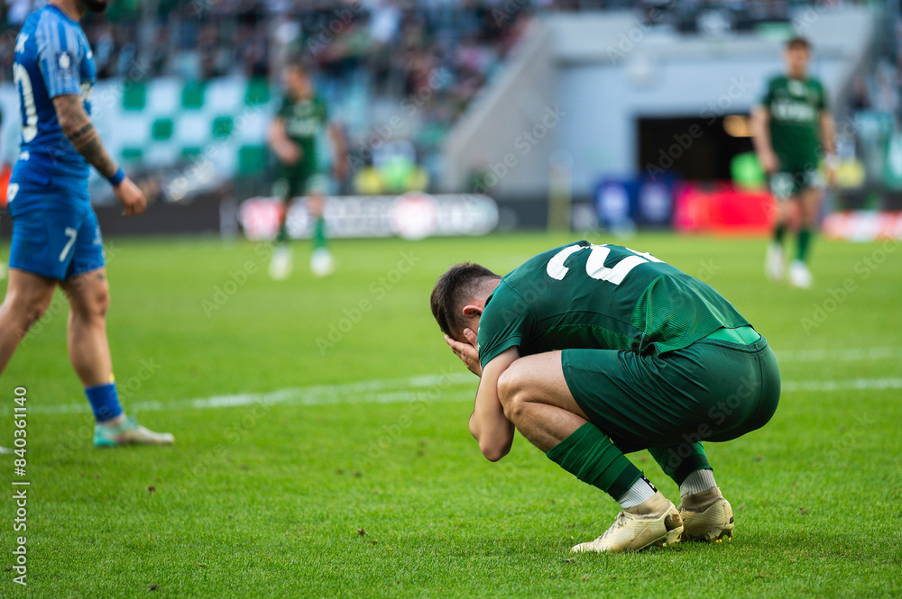 Footballer after missing shoot during soccer match.