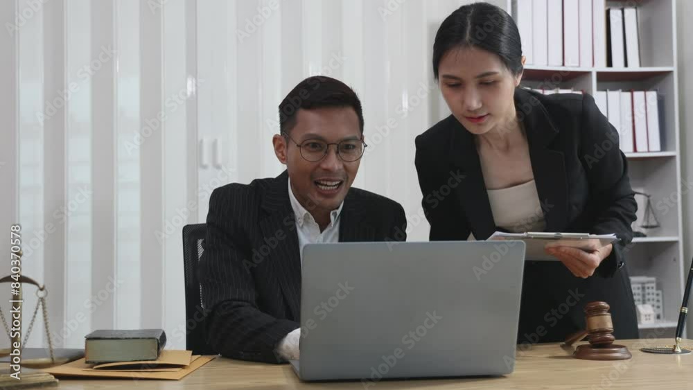 Lawyer reads consultation term between male lawyer and client, tax business and law firm with brass scales on table in law office Lawyer reads consultation term between male lawyer and client, tax business and law firm with brass scales on table in law office