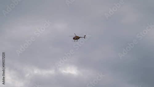 Helicopter Soaring in the Sky on a Bright Day in 4k slow motion 60fps photo