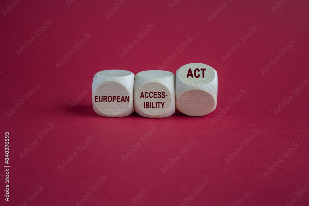 Cubes form the expression 'European Accessibility Act' as symbol for the new European law in 2025. Beautiful red background. Copy space.