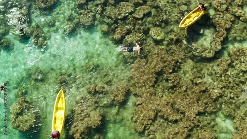 Aerial drone of Man snorkeling in turquoise tropical lagoon. tourist snorkeling in coral reef. Small lagoon with turquoise water. El nido, Philippines, Palawan. Summer and travel vacation concept. photo