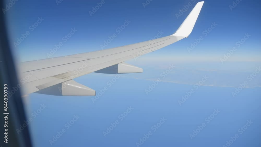 Airplane wing over earth terrain, showcasing the journey and perspective in 4k slow motion 120fps Airplane wing over earth terrain, showcasing the journey and perspective in 4k slow motion 120fps