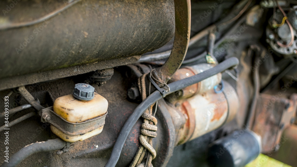 An old farm tractor. View of headlights, engine and cabin An old farm tractor. View of headlights, engine and cabin