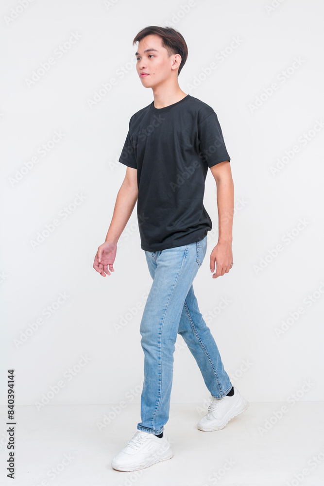 Casual young asian man walking in black shirt and jeans Casual young asian man walking in black shirt and jeans