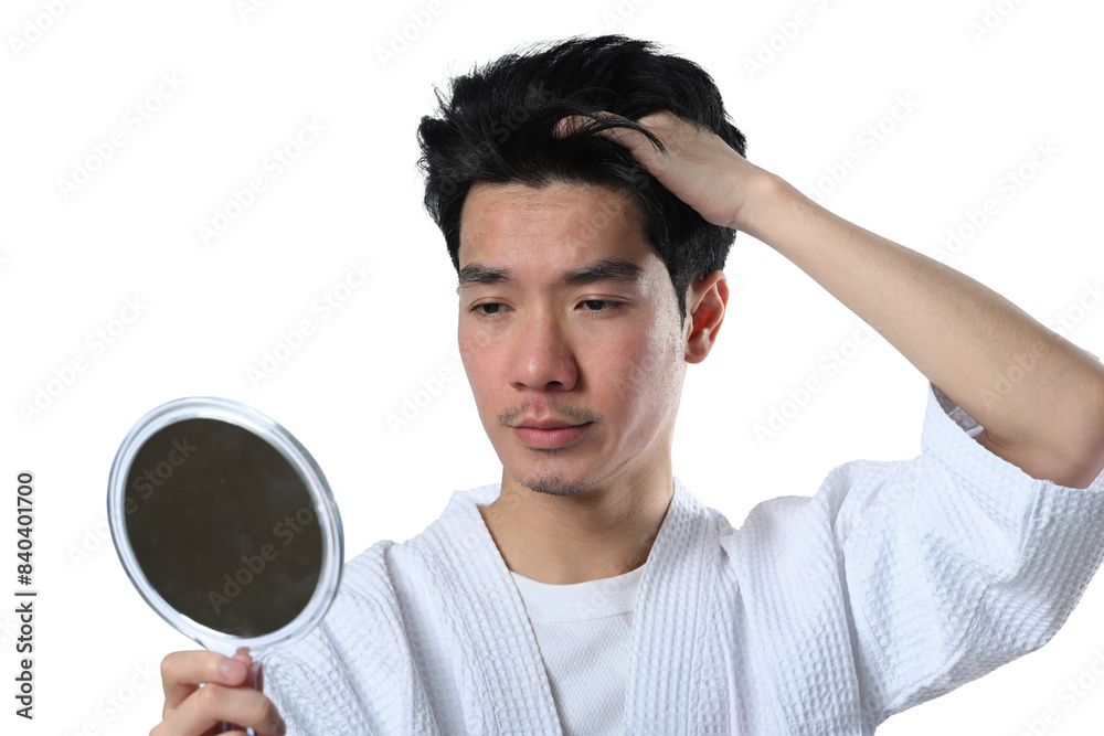 Young Asian man after facial laser treatment looking at the mirror isolated on white background Young Asian man after facial laser treatment looking at the mirror isolated on white background