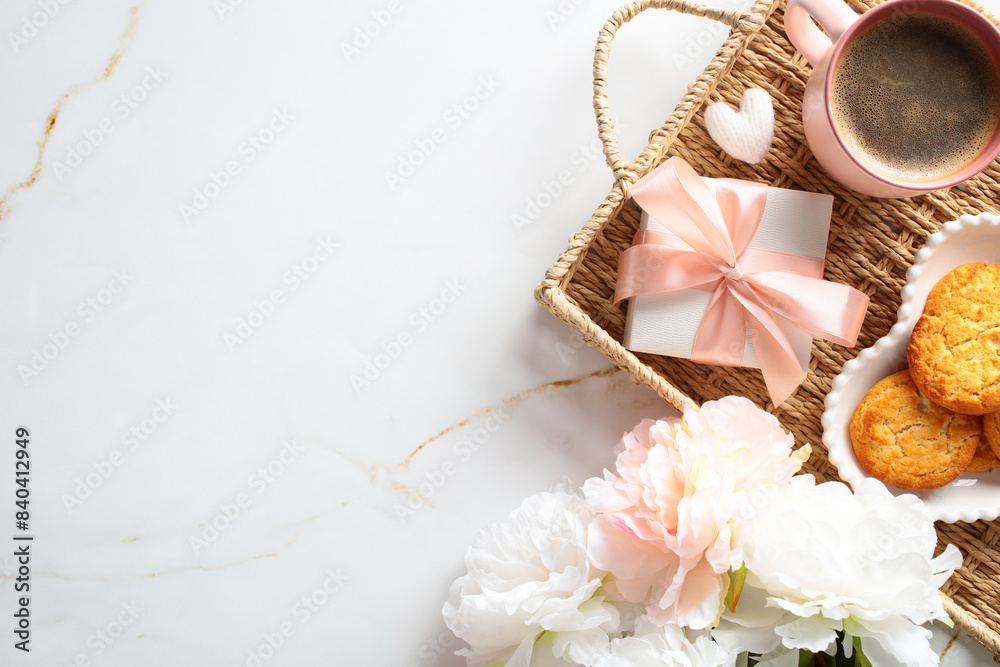 Elegant morning coffee setup with cookies, a gift, and flowers on a marble background, perfect for a cozy start to the day. Elegant morning coffee setup with cookies, a gift, and flowers on a marble background, perfect for a cozy start to the day.