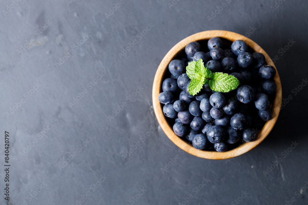 Ripe organic blueberries on black stone table background. Selective focus. Ripe organic blueberries on black stone table background. Selective focus.