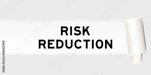 Ripped gray paper background that have word risk reduction under torn part
