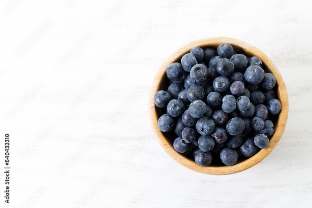 Ripe organic blueberries on white wooden table background. Selective focus. Ripe organic blueberries on white wooden table background. Selective focus.