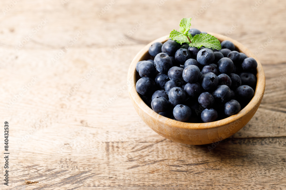 Ripe organic blueberries on wooden table background. Selective focus.