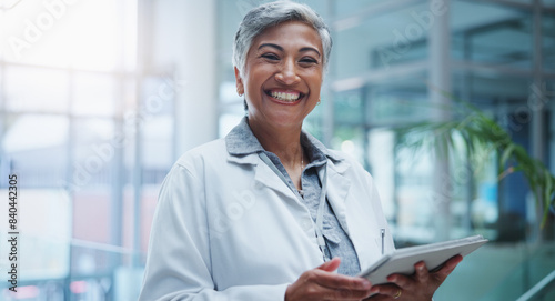 Female doctor, portrait and smile with tablet in hospital or workplace with lens flare. Communication, technology and medical research for innovation in medicine with happy healthcare professional.