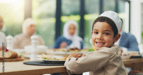 Photography Children, eid and portrait of muslim boy eating food with family in dining room of home for celebration