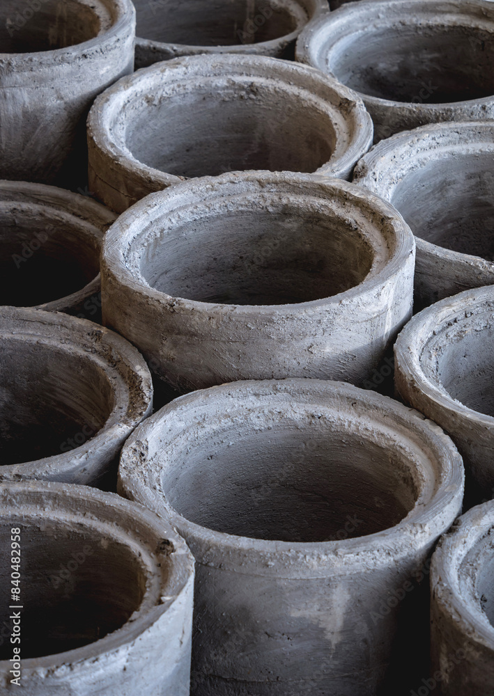 A stack of concrete ring pipes piled and creating a symmetrical arrangement A stack of concrete ring pipes piled and creating a symmetrical arrangement