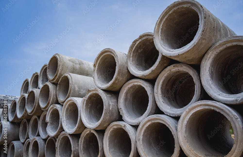 A stack of concrete ring pipes piled and creating a symmetrical arrangement A stack of concrete ring pipes piled and creating a symmetrical arrangement