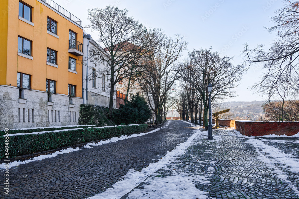 Buda Castle with buildings next to cobblestone pathway in winter with melting snow around, Budapest, Hungary Buda Castle with buildings next to cobblestone pathway in winter with melting snow around, Budapest, Hungary
