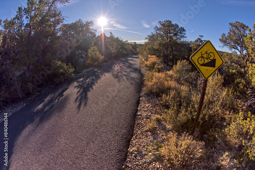The paved Greenway trail west of Monument Creek Vista with a sign warning cyclists of a steep gradient ahead, Grand Canyon, Arizona, United States of America