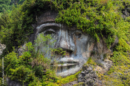 Large carved face at Bukit Kasih, a volcanic tourist park with fumarole fields, a world peace themed tower and worship houses of five major religions, Bukit Kasih, Minahasa, North Sulawesi, Indonesia